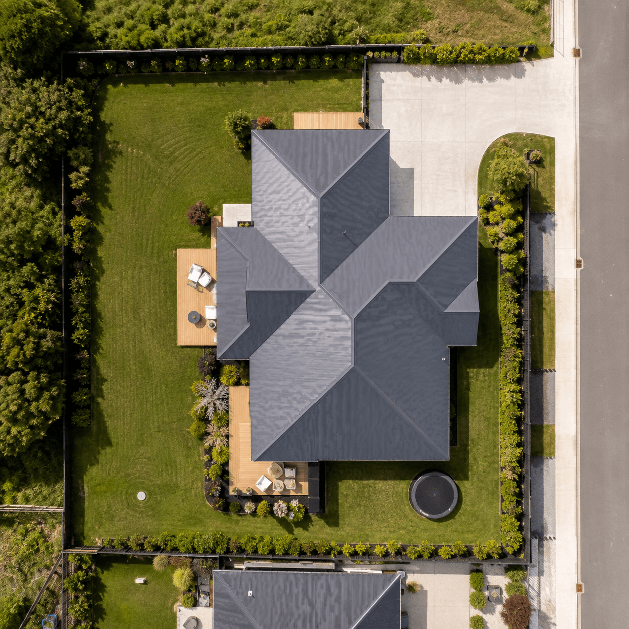 Top-down aerial view of a home, garden, and driveway