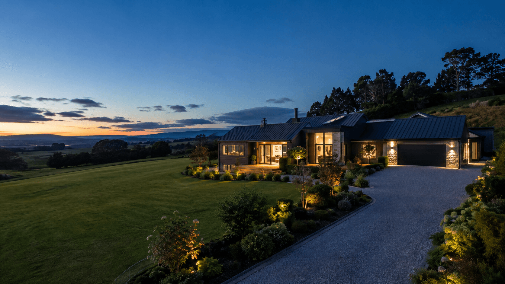 Aerial drone photograph of a modern lifestyle home at dusk